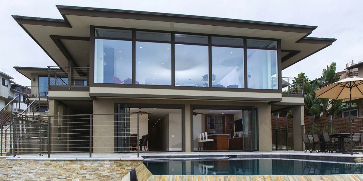 A large house with a pool and a glass window.