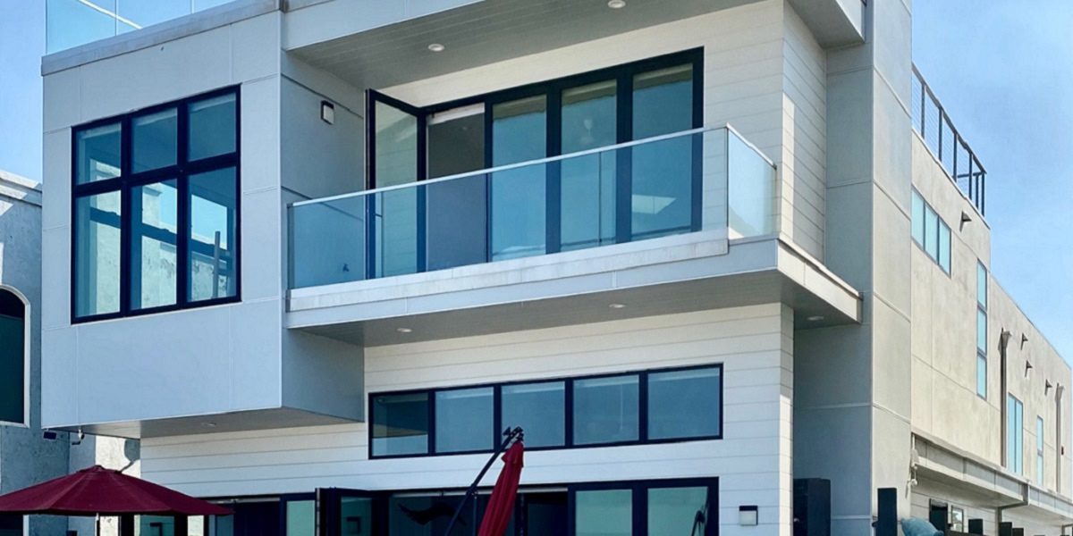 A building with two floors and glass balconies.