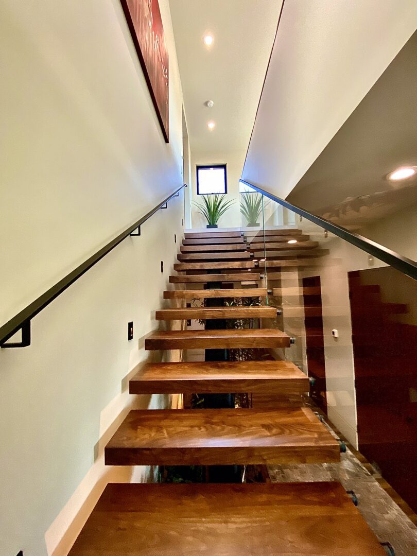 A wooden staircase with metal handrails and steps.