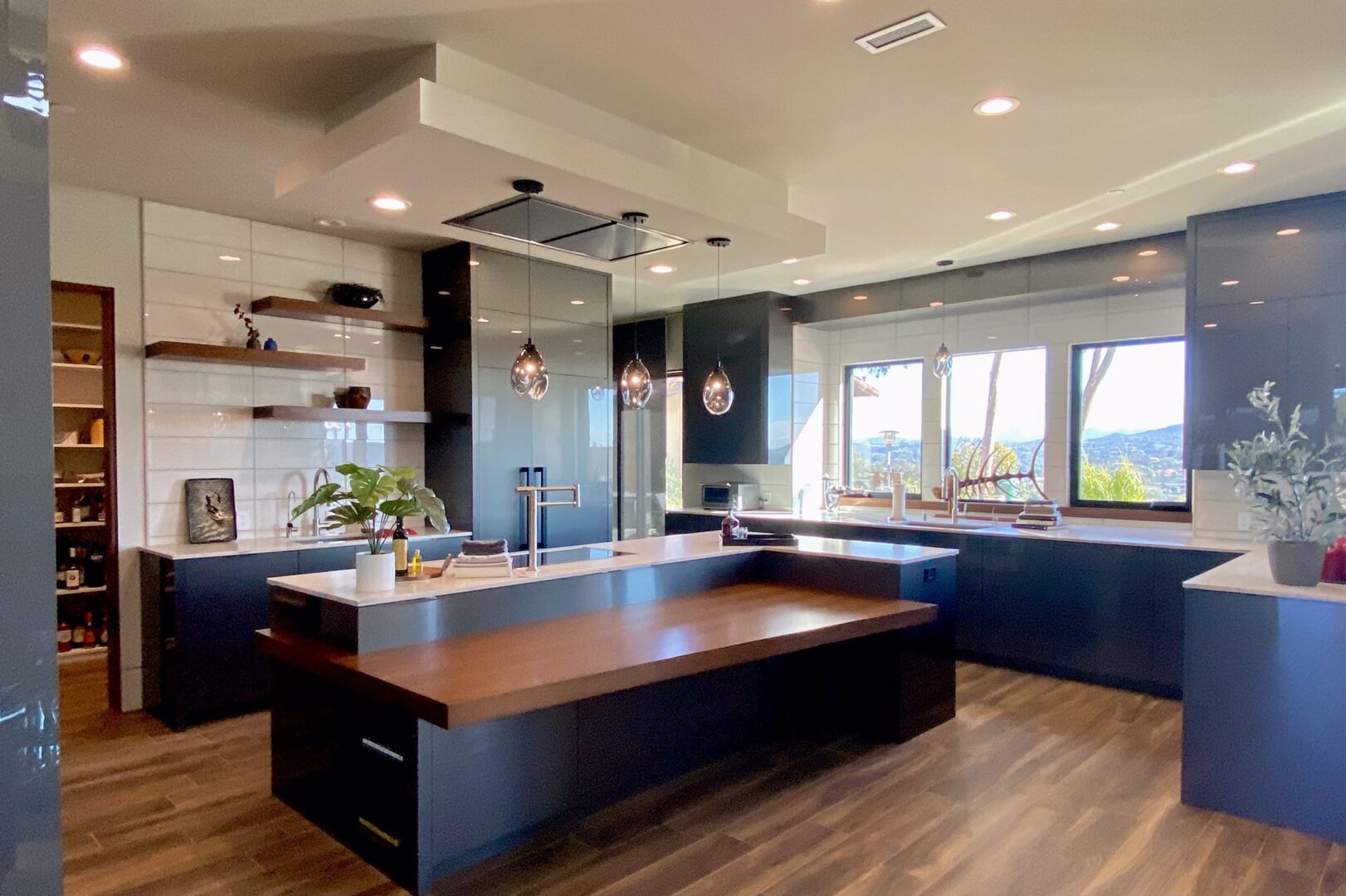 A kitchen with a large island and wooden floors